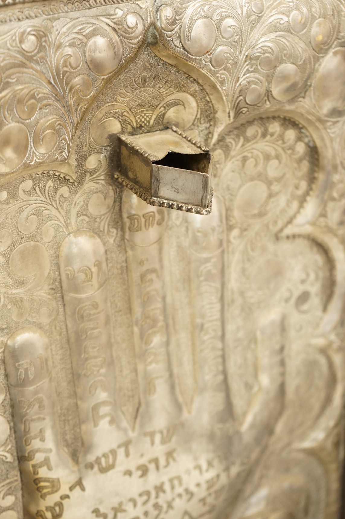 A Jewish embossed white metal menorah, 51cm high